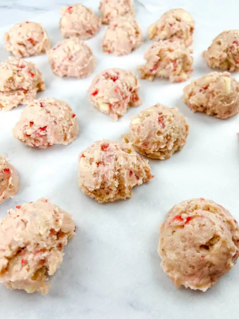 strawberry shortcake cookies dough balls on a baking sheet