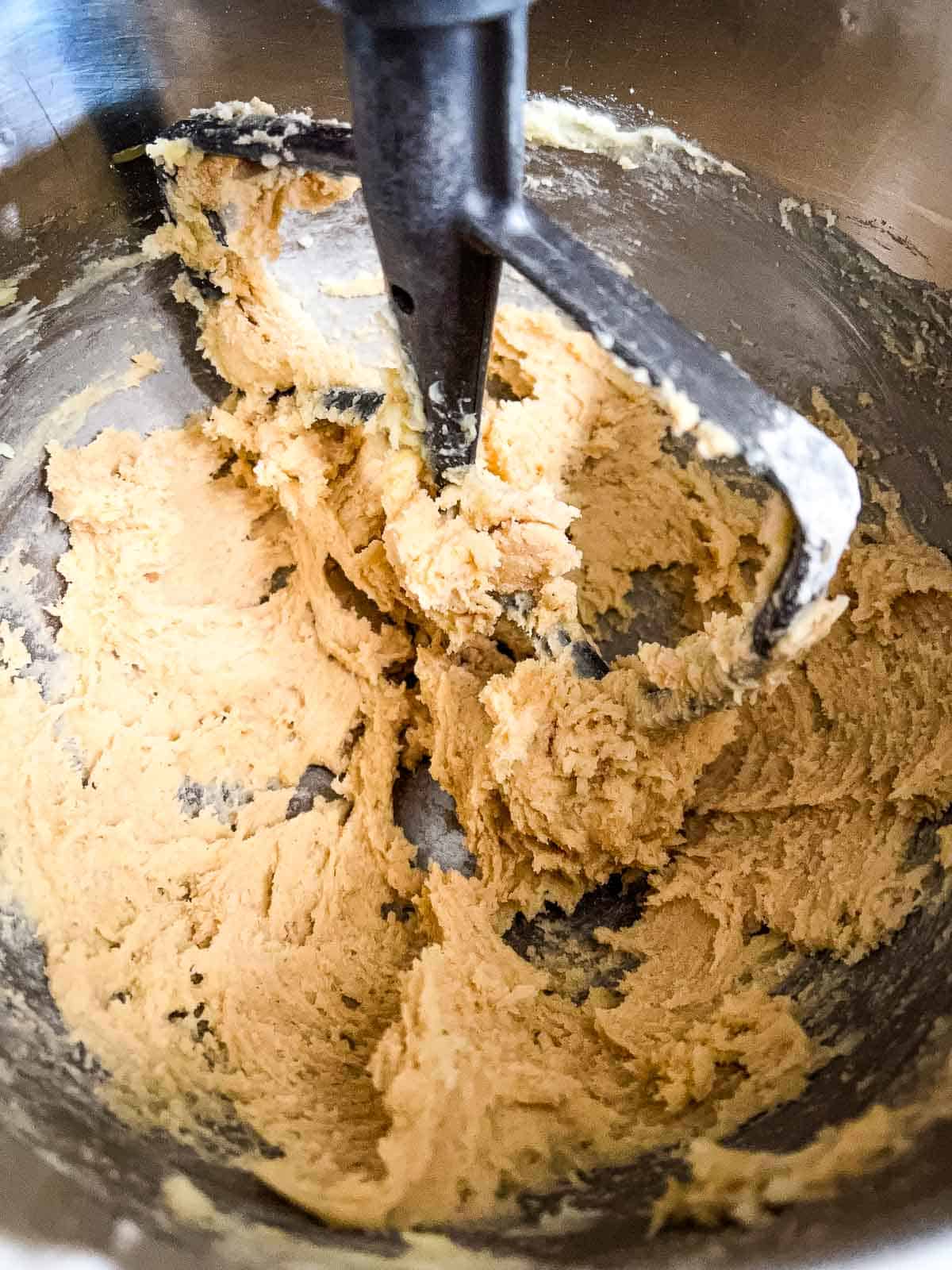 adding the flour to the cookie dough