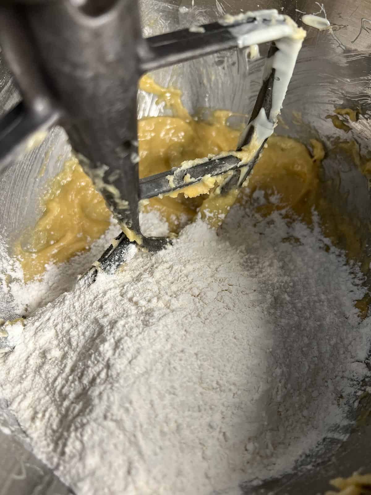 adding flour to the cookie dough