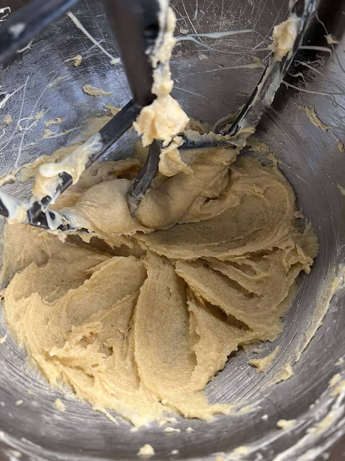 drizzle white chocolate into butter sugar mixture