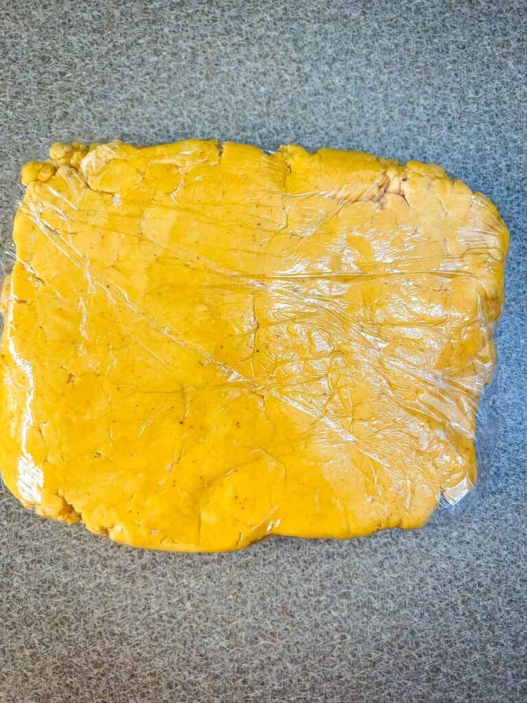 dough wrapped in plastic to be refrigerated