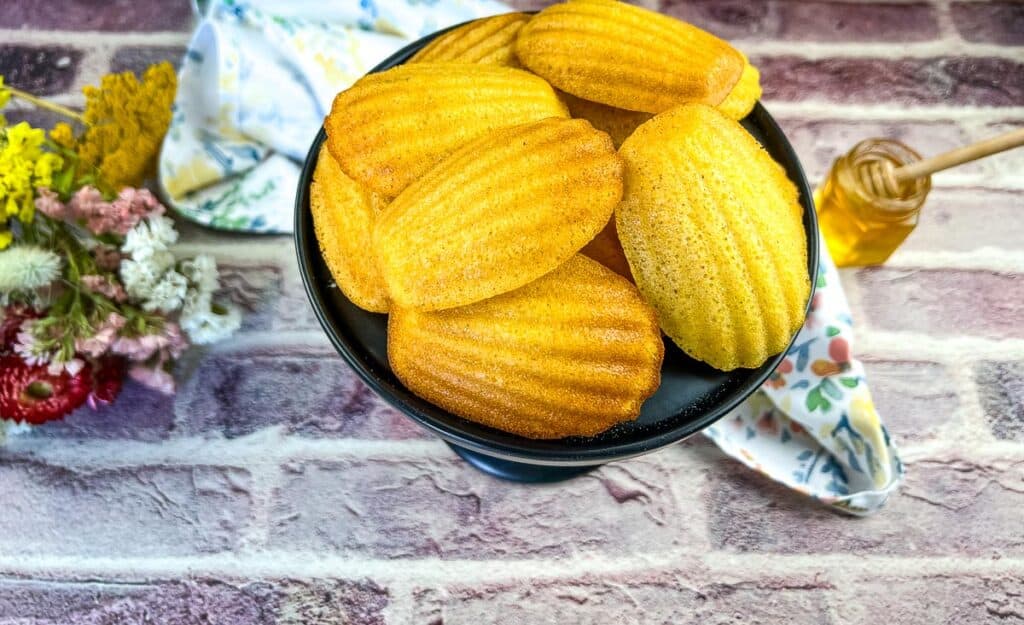 honey butter cornbread madeleines on a black pedestal