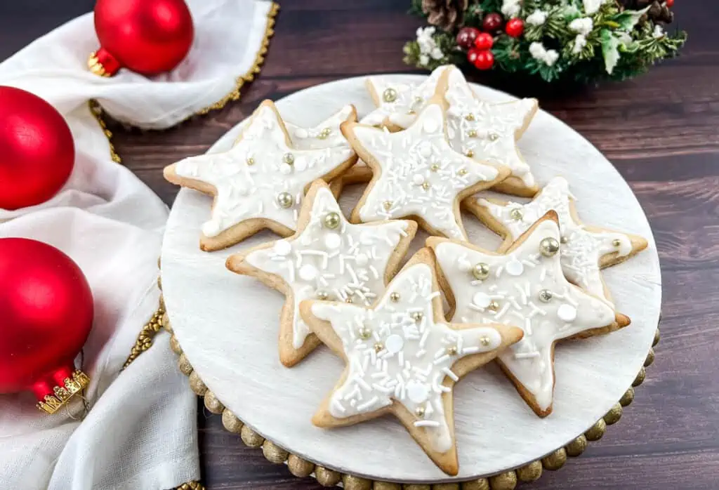 Eggnog sugar cookies on a wooden platter.