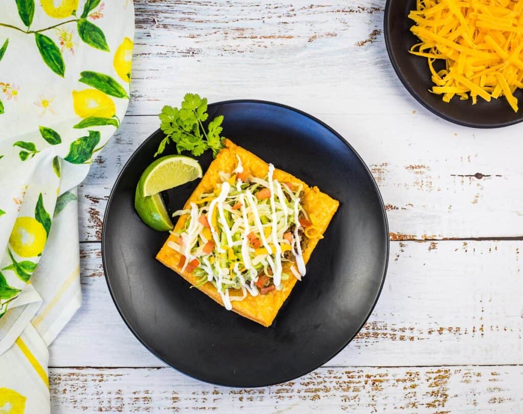 Cheez-It Tostadas served on a black plate.