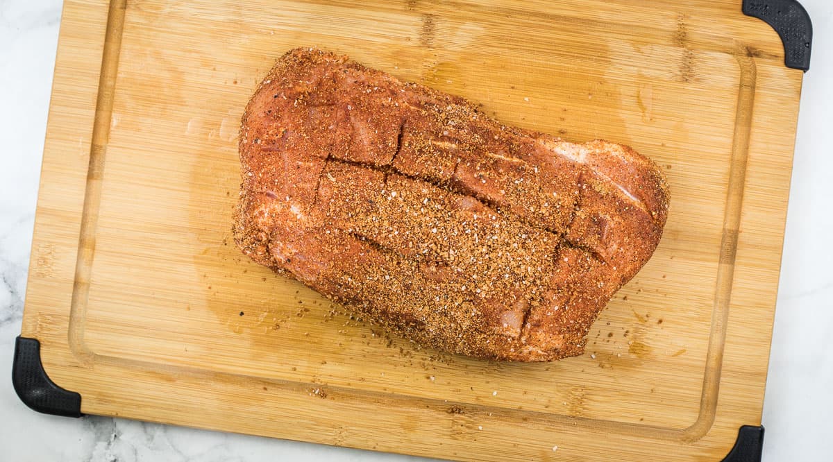 Score and rub the meat with the spice rub