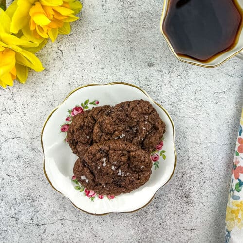 Salted dark chocolate cookies on a white plate.