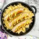 cooked sausage on a blackstone served on top of sauerkraut