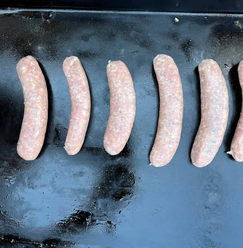 raw sausage on a blackstone griddle