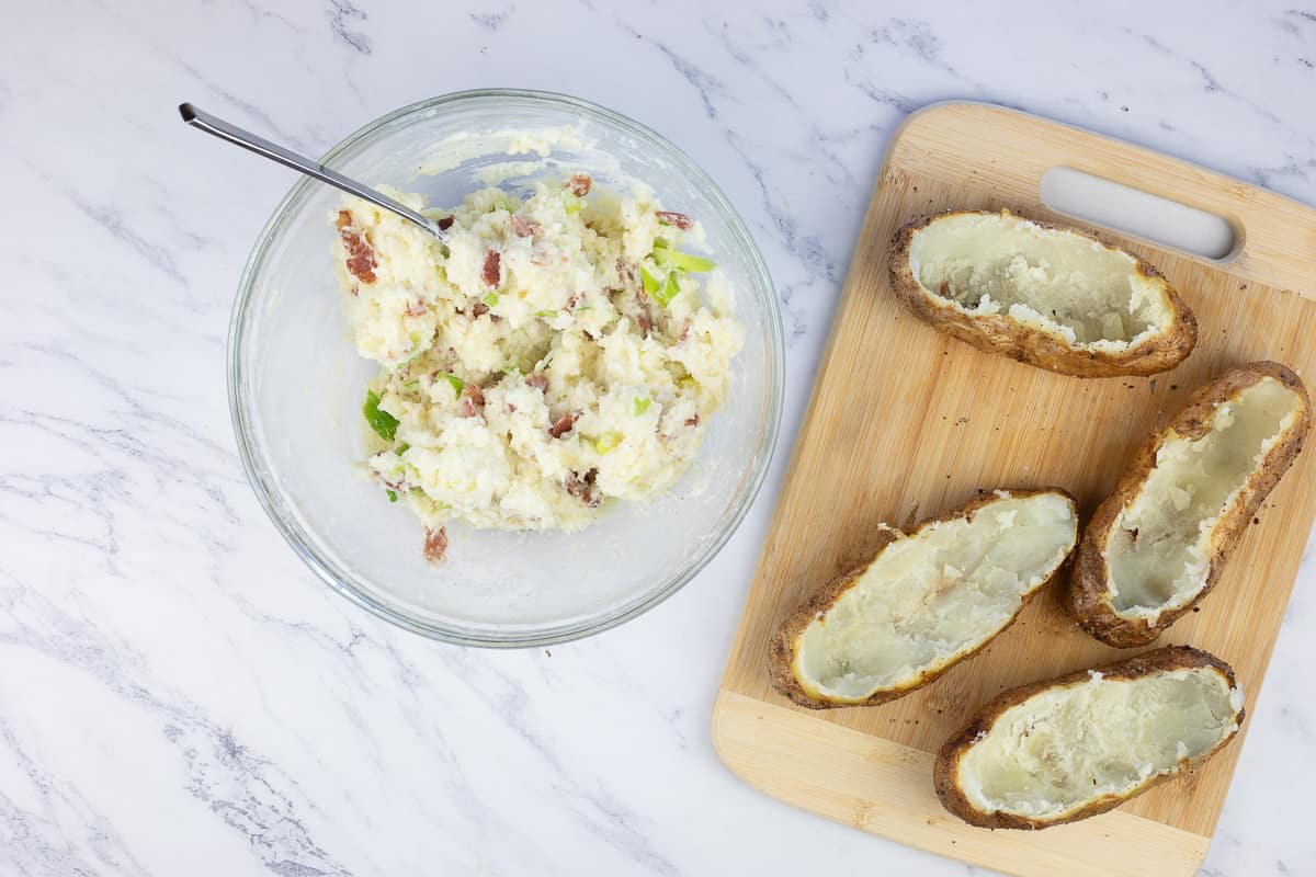 scooped potatoes with the mashed filling in a bowl