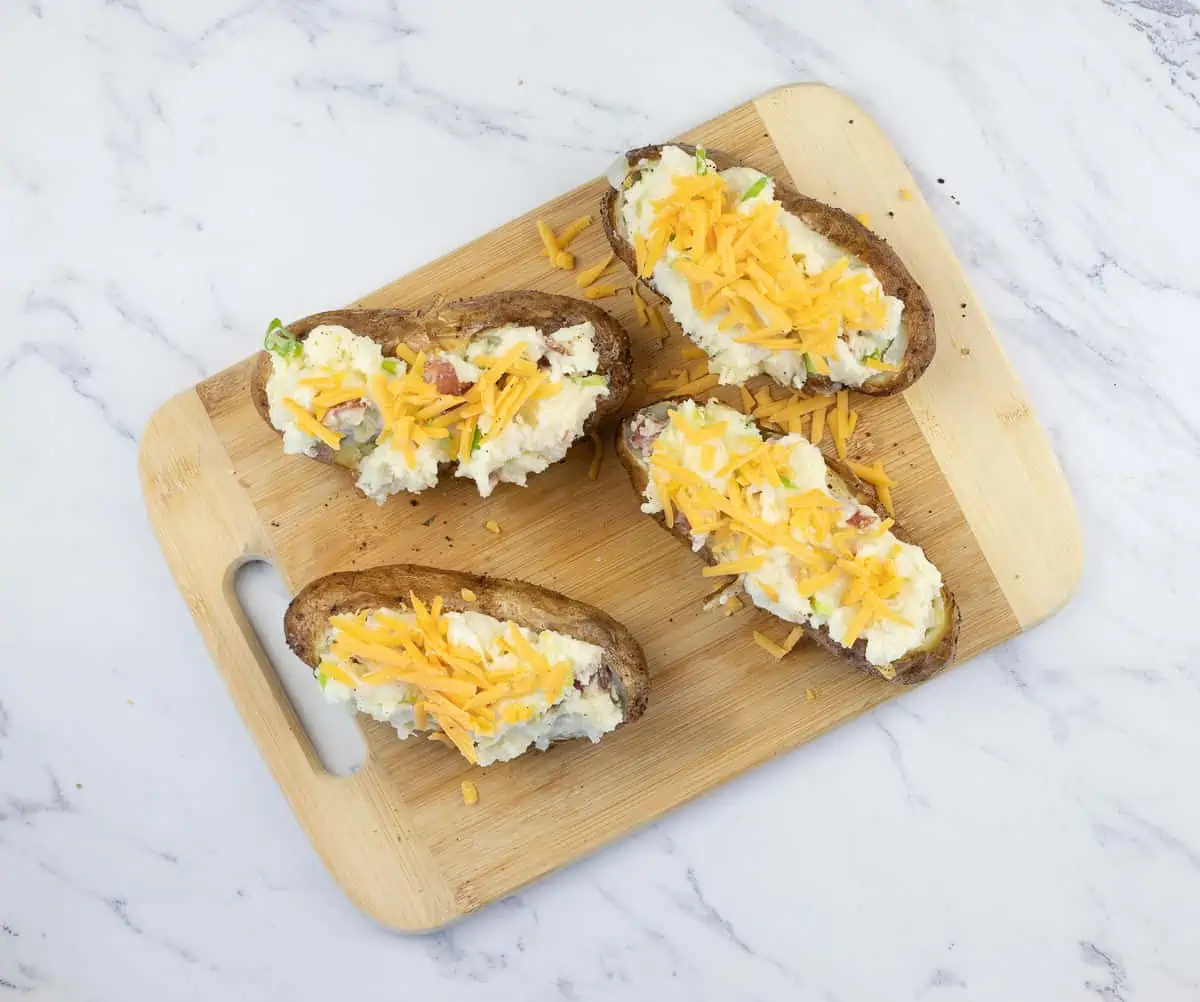 restuffed potatoes topped with cheese for the smoker