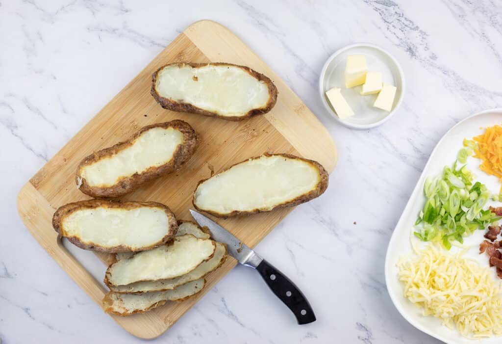 Smoked baked potatoes with the lids cut off.