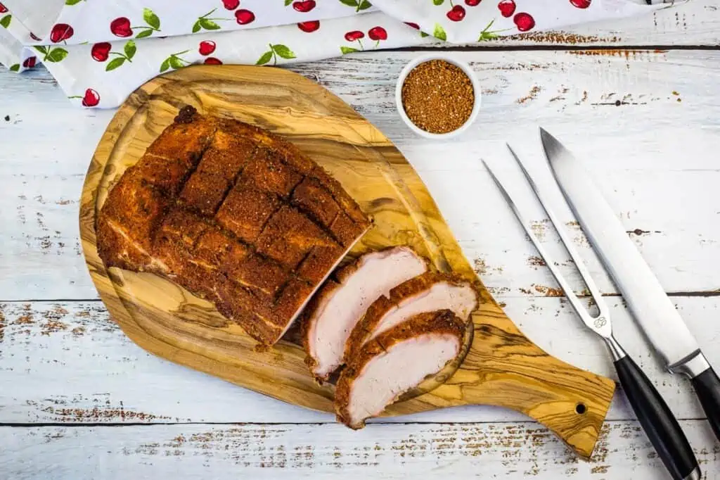 sliced smoked pork loin on a cutting board