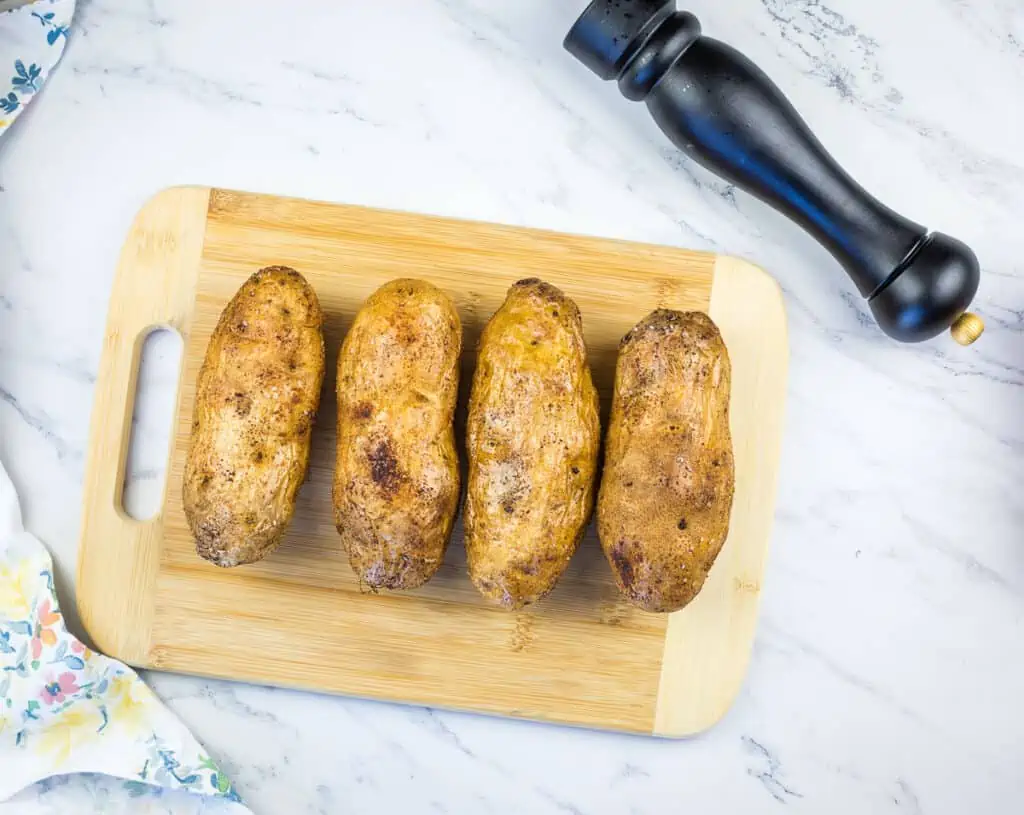 russet potatoes on a cutting board ready for the smoker