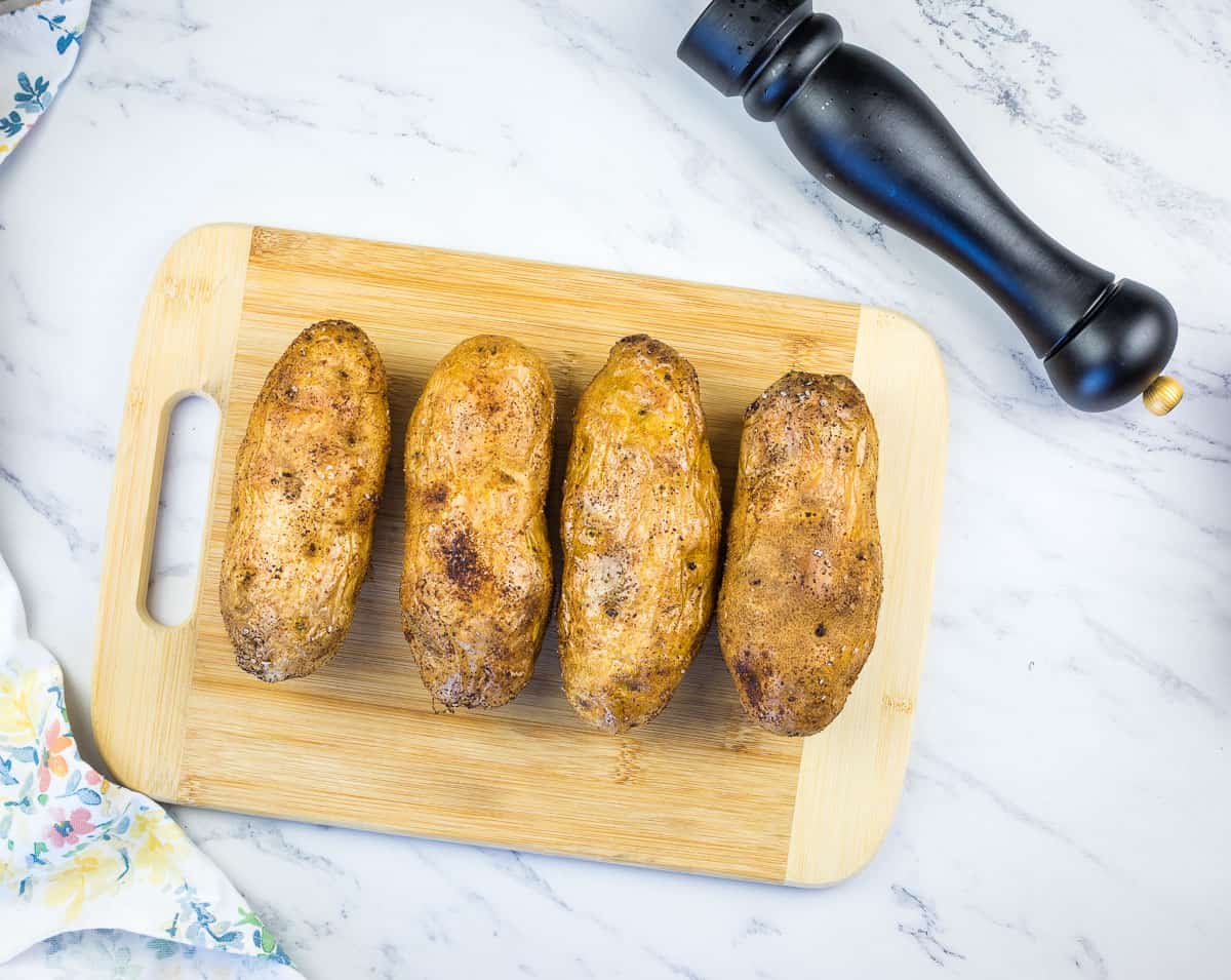 russet potatoes on a cutting board ready for the smoker
