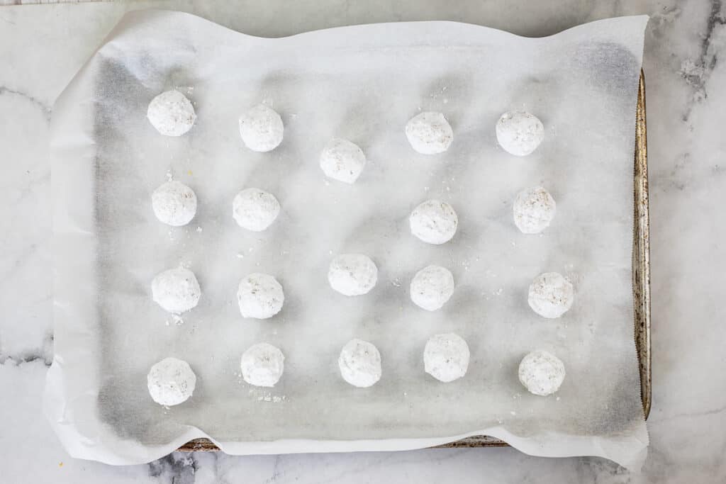 white chocolate crinkle dough balls rolled in powdered sugar