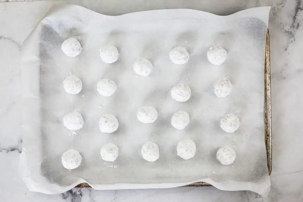 white chocolate crinkle dough balls rolled in powdered sugar