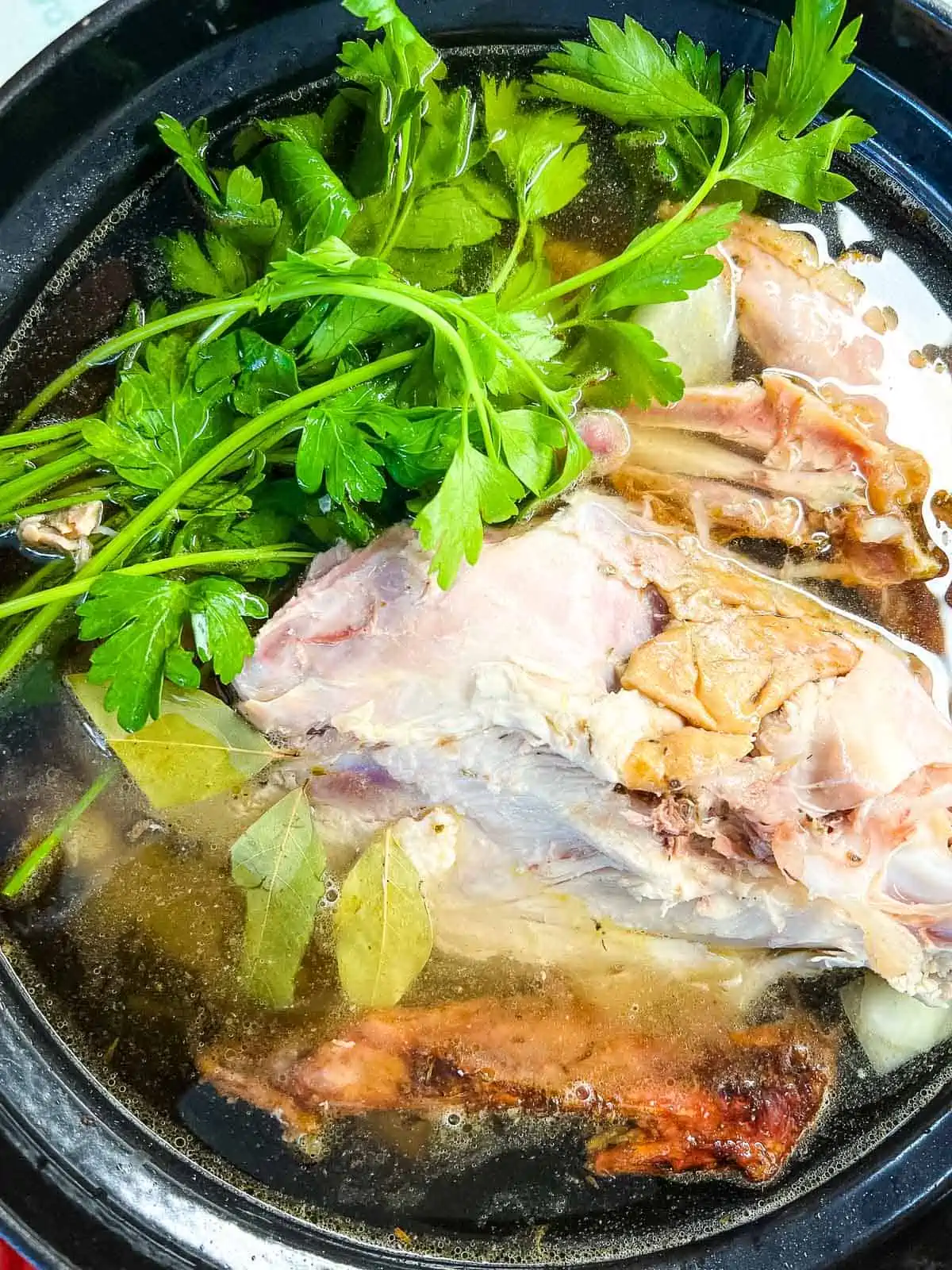 Turkey carcass, water, and additional ingredients added to the pot.
