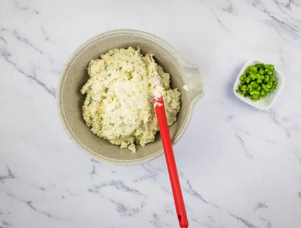 A bowl of the dip with dice jalapenos to mix in.