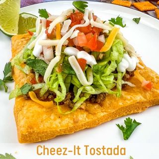 A closeup of a Cheez-it tostada on a white plate.