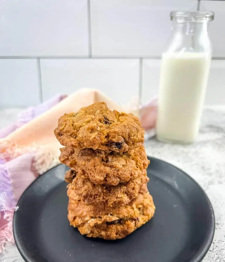 A stack of air fryer oatmeal raisin cookies and a bottle of milk.
