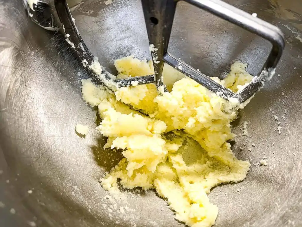 Creaming the butter and sugar in a bowl.