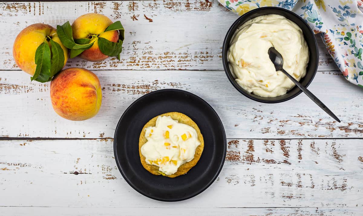 Finished Peaches and Cream Cookie with a bowl of topping in the background.
