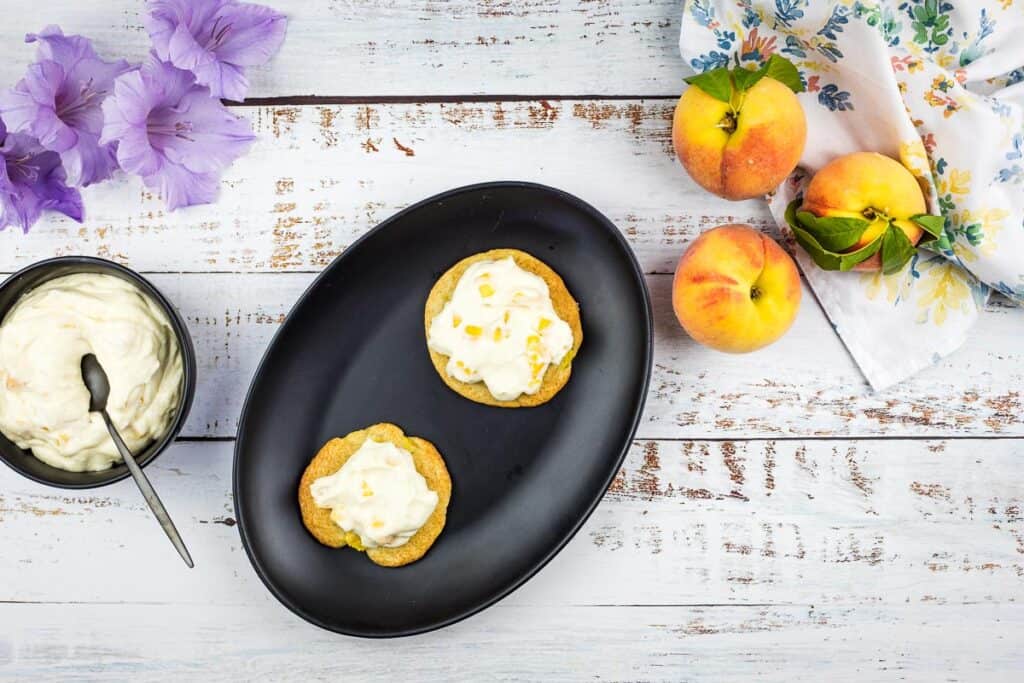 peaches and cream cookies on a black plate.