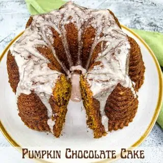 Pumpkin chocolate cake with a wedge cut out of it.