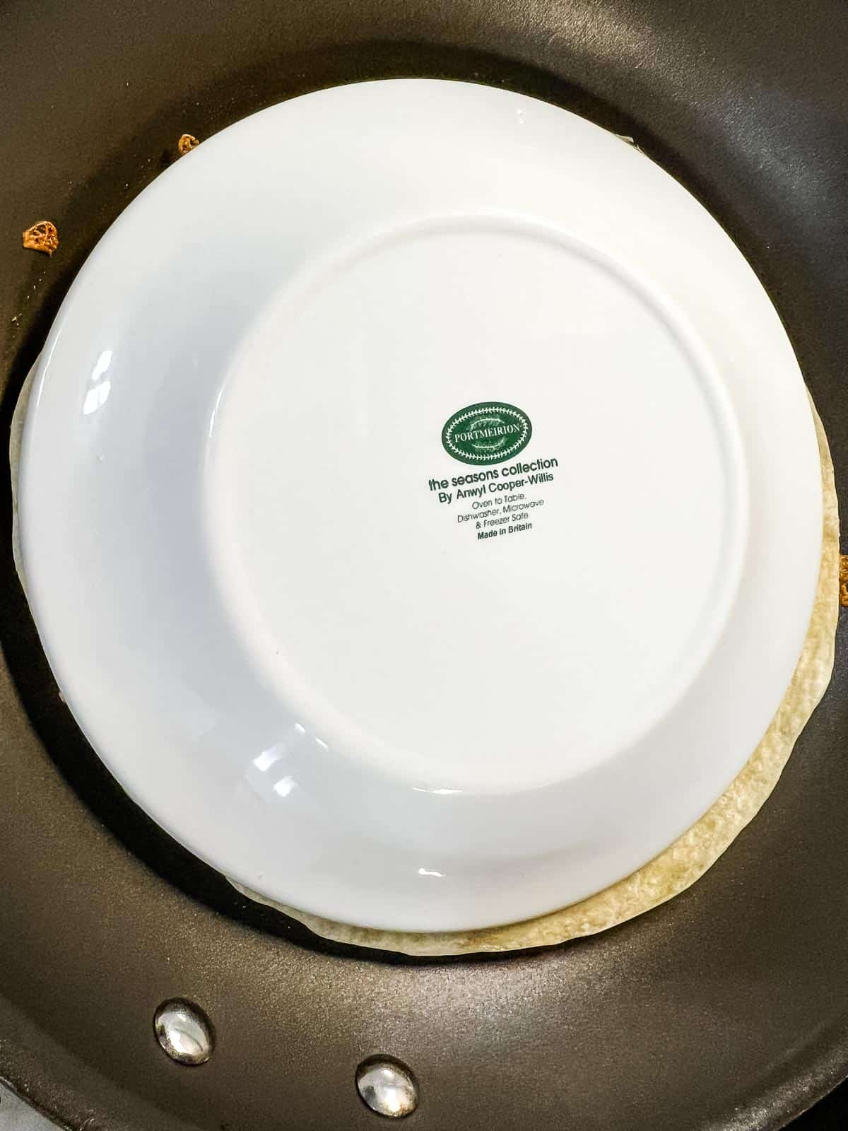 Use an inverted plate to flip the quesadilla.