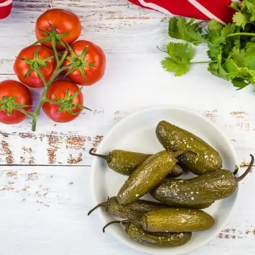 Smoked jalapenos on a plate.