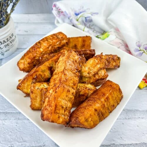 Sweet and spicy smoked pineapple on a white plate.