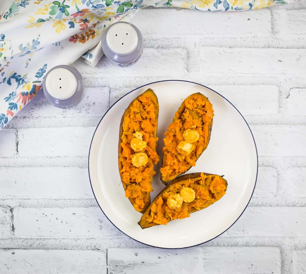 Smoked Sweet Potatoes with Chipotle Butter on a round white plate.