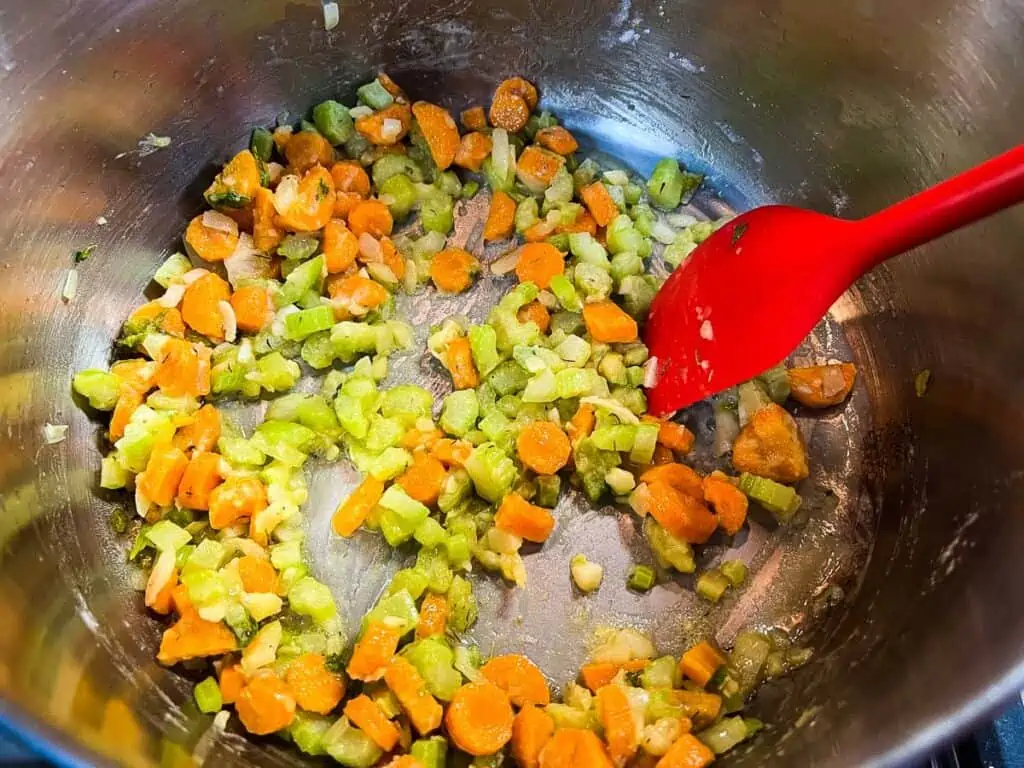 Adding flour to the veggies.