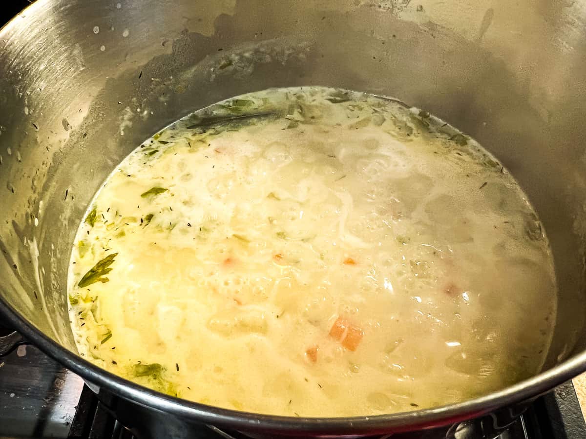 Simmering to cook the potatoes.