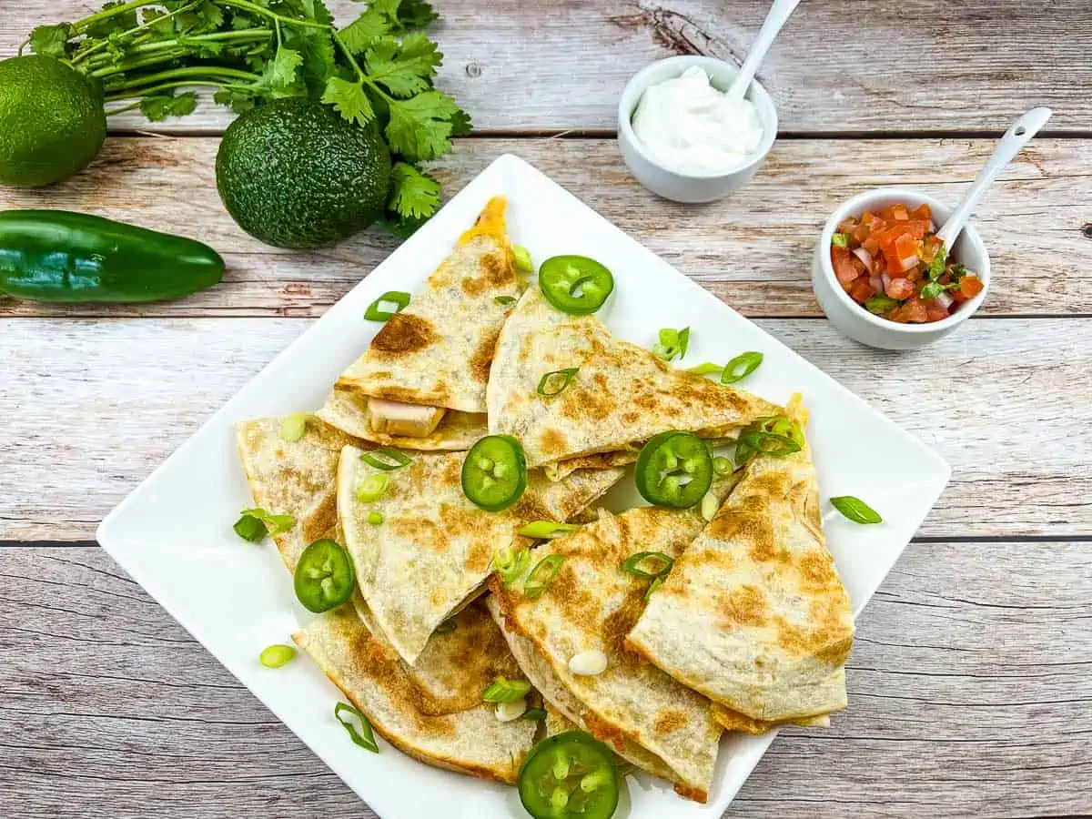 smoked turkey quesadilla on a white plate.