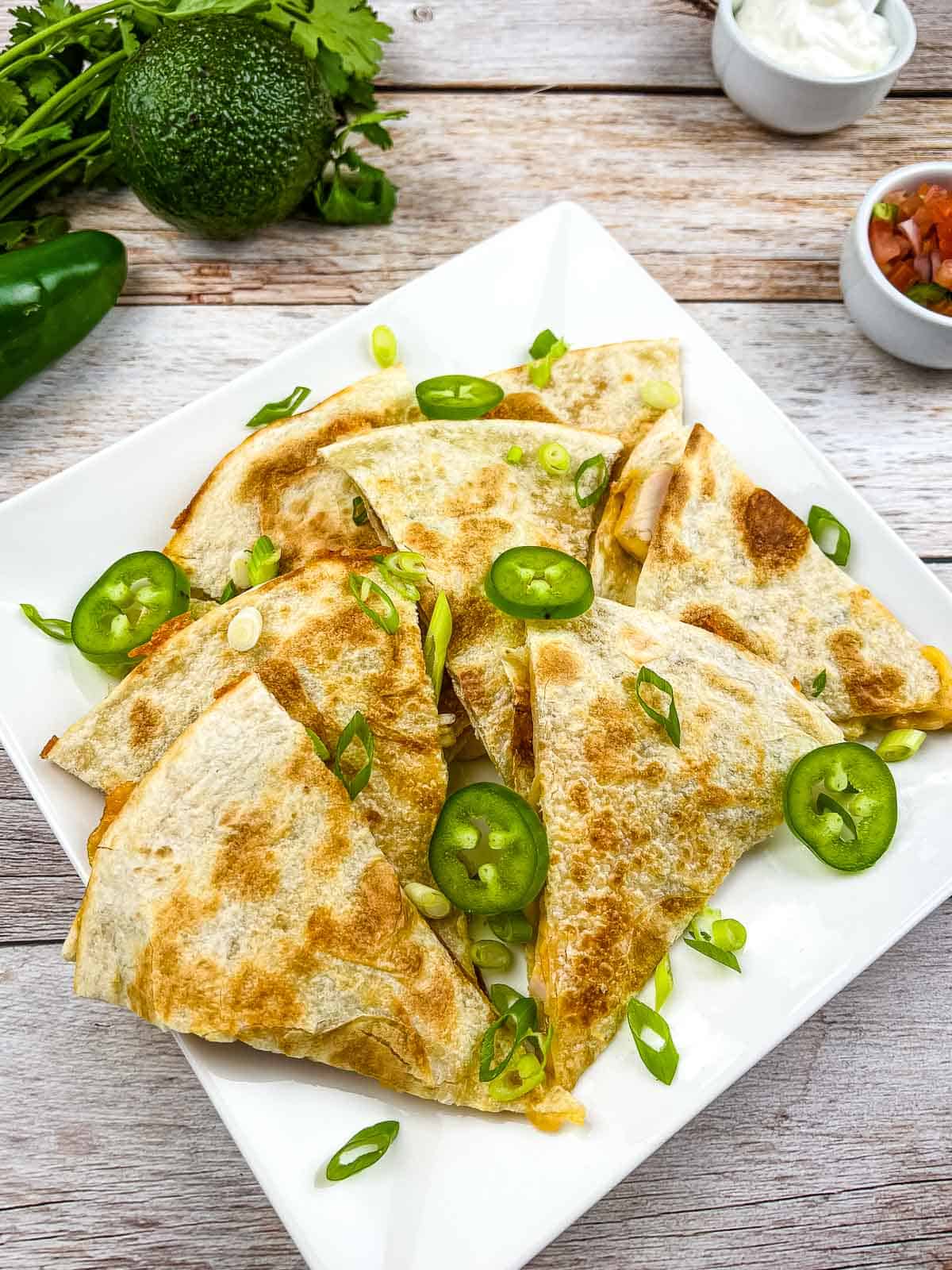 Smoked turkey quesadilla cut in wedges on a plate.