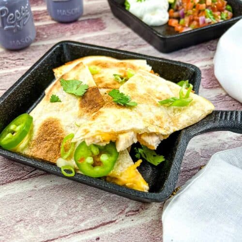Smoked turkey quesadilla in a black cast iron dish.