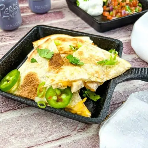 Smoked turkey quesadilla in a black cast iron dish.