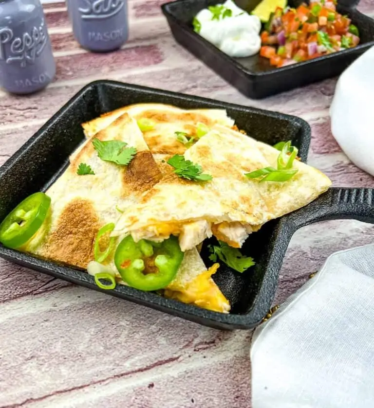 Smoked turkey quesadilla in a black cast iron dish.