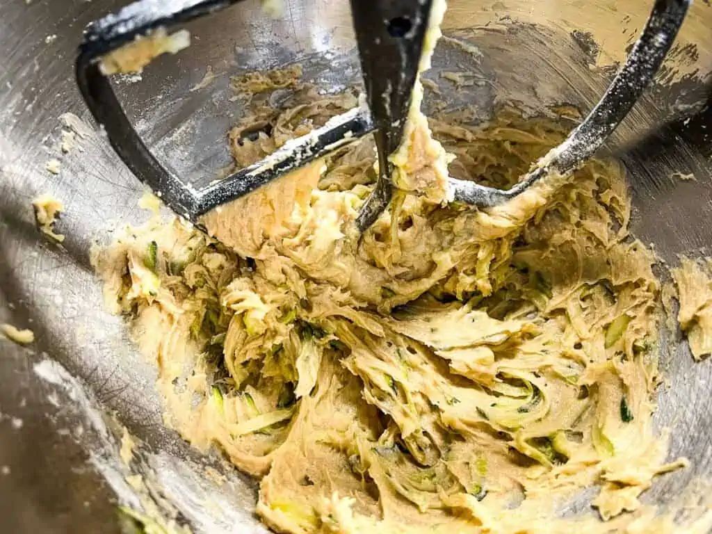 Mixing in the zucchini and dry ingredients.