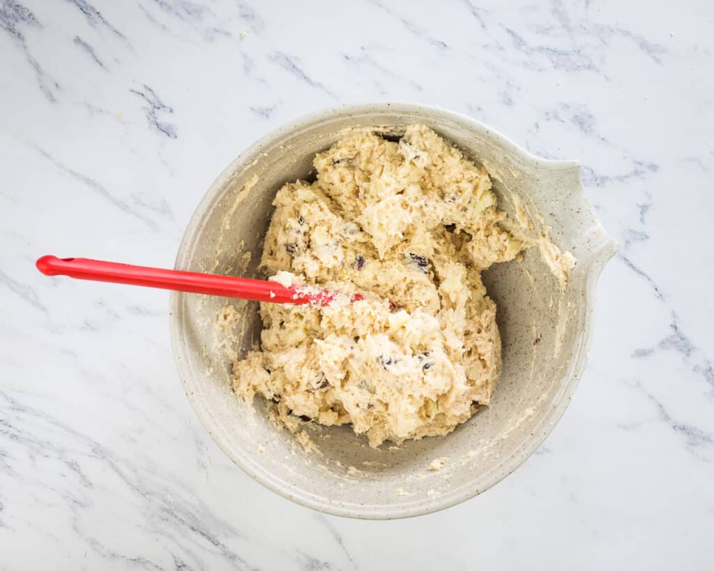 Apple, Date, and Walnut Muffin batter mixed in a bowl.