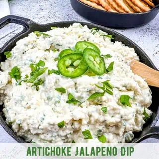 Artichoke Jalapeno Dip in a black serving dish.