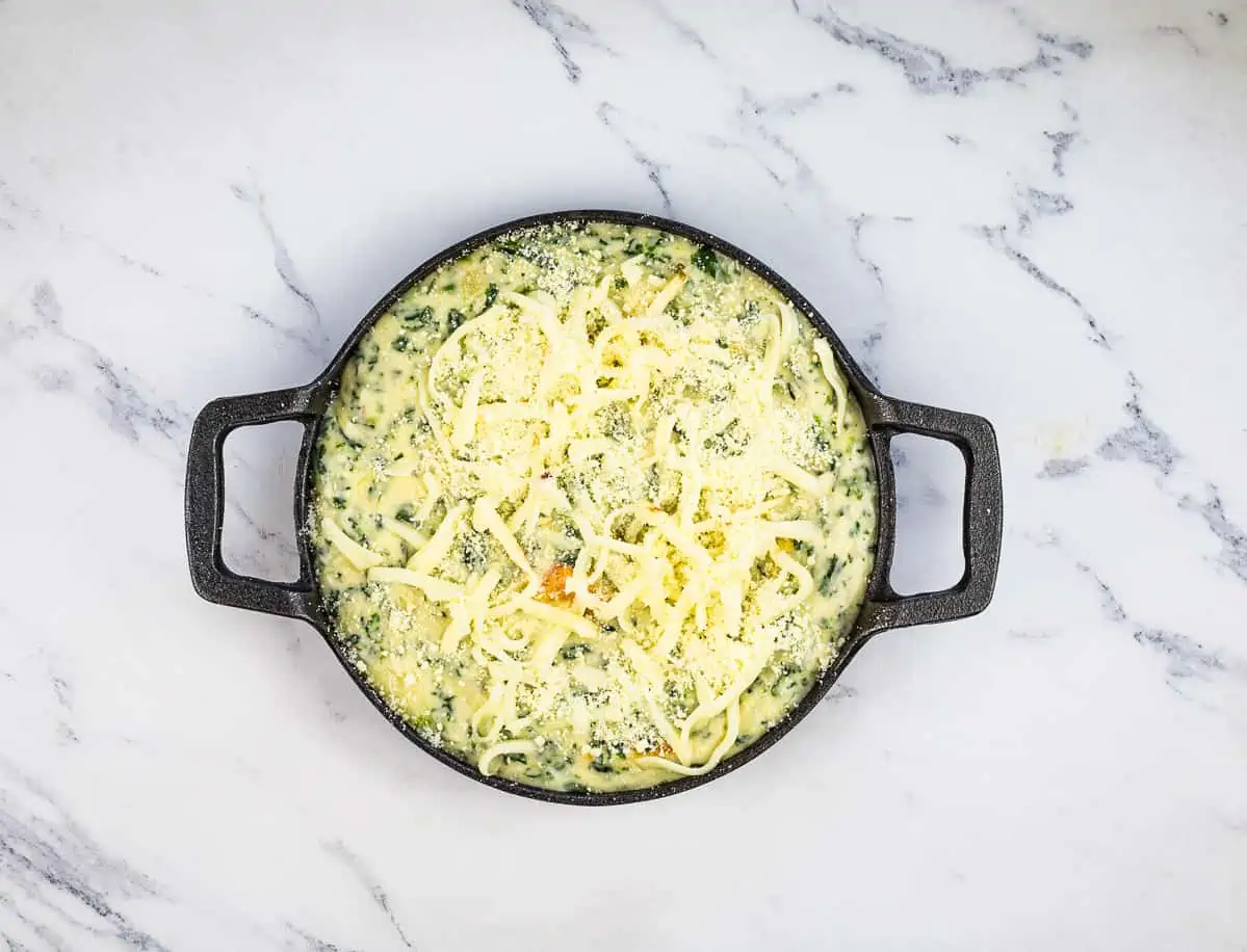 Spinach and Brie Dip in a baking dish ready for the oven.