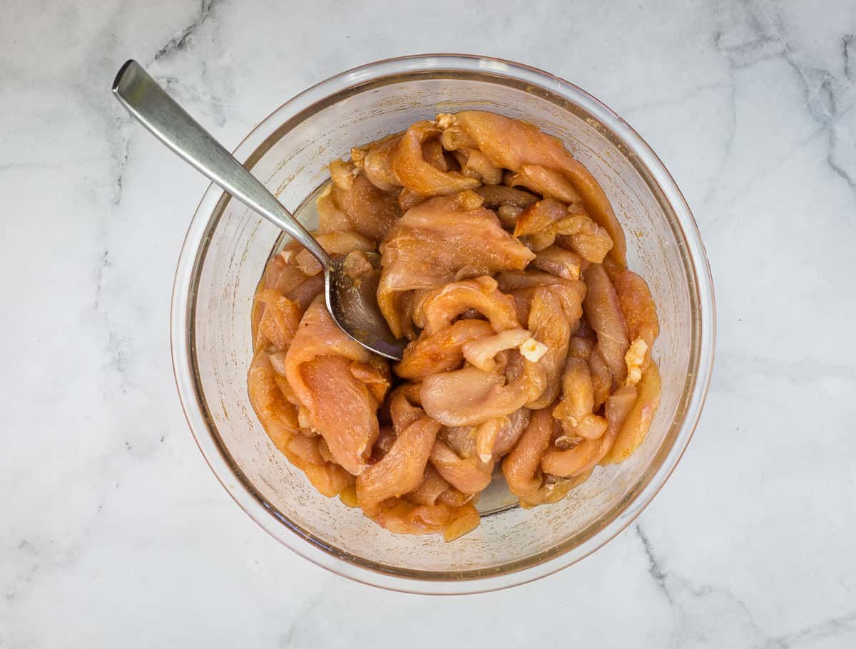 Chicken mixed with the spices.