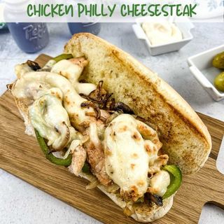 Chicken Philly Cheesesteak on a cutting board.