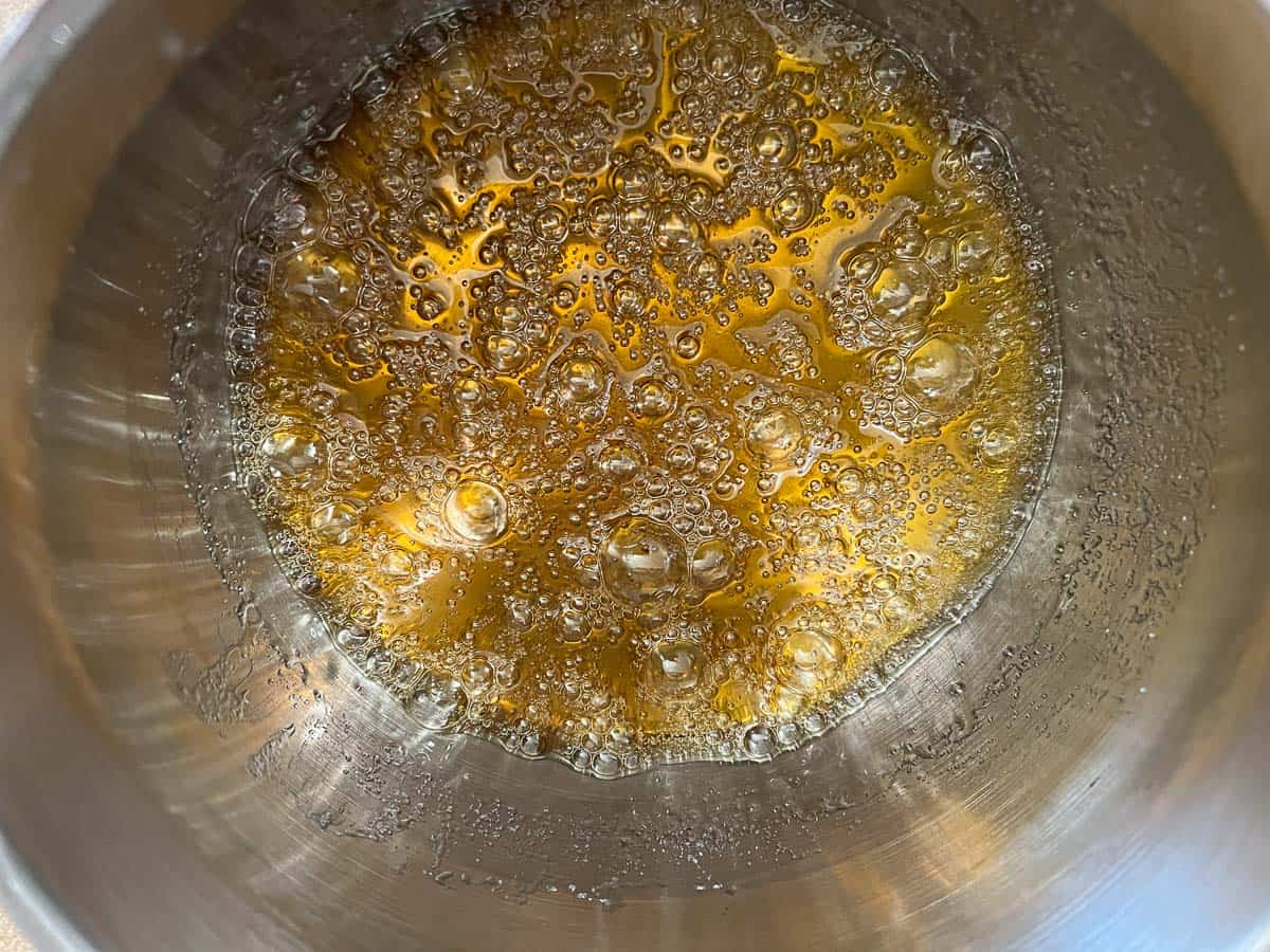 Golden brown caramel bubbling in a pan.