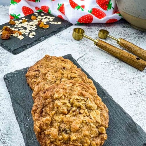 Oatmeal raisin cookies on a black dish.