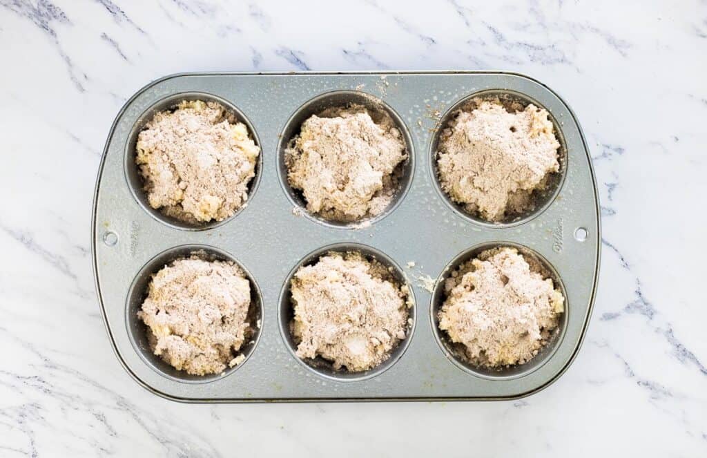 Muffin cups filled about 3/4 full.