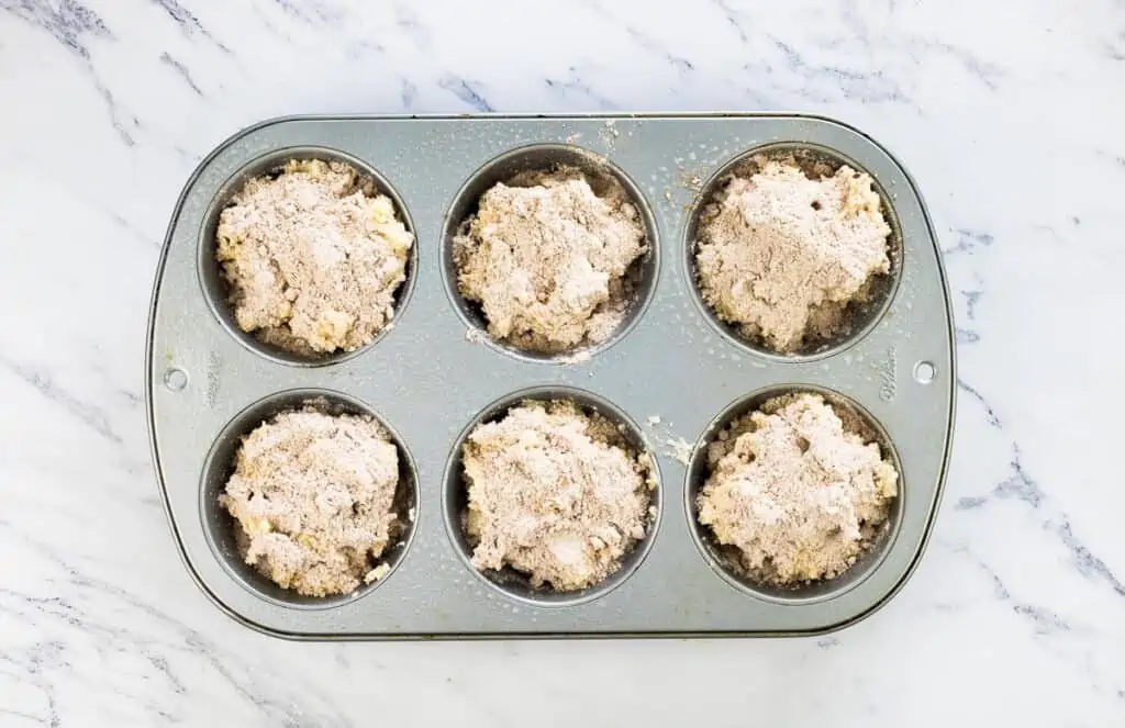 Muffin cups filled about 3/4 full.