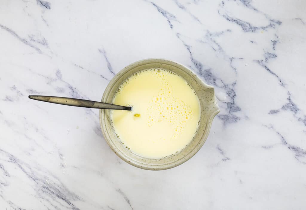 Egg and milk mixed in a smaller bowl.